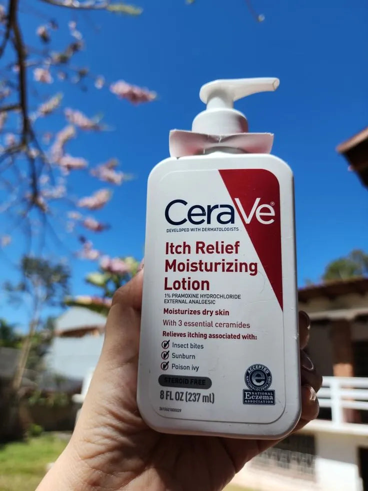 CeraVe Itch Relief Moisturizing Lotion held in a hand with a blurred outdoor background