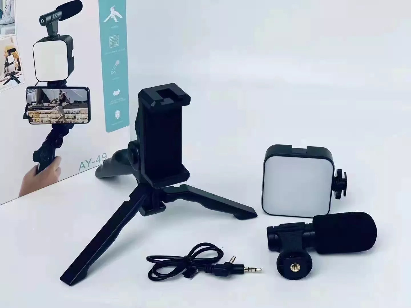 Phone holder with tripod, microphone, and cable on a white background