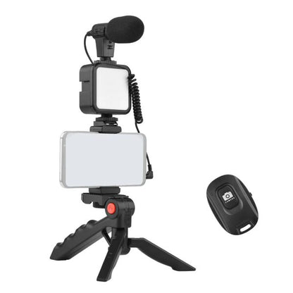 Video recording setup with microphone, light, and remote control on a white background