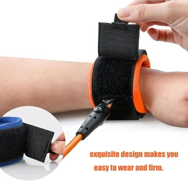 Person wearing an orange and black wrist support device with text on a white background