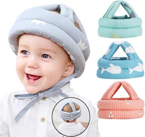 Baby wearing a gray helmet with additional helmets in different colors displayed above.