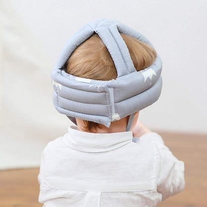 Child wearing a gray headband with straps on a neutral background
