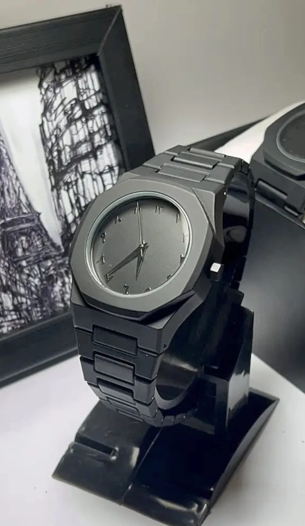 Black wristwatch on a stand with blurred background