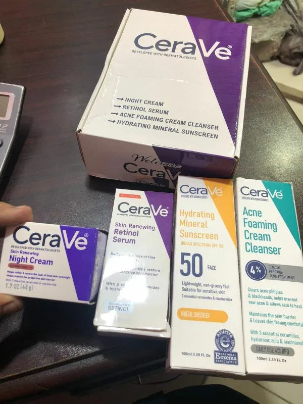 Cerave skincare products including night cream, serum, cleanser, and sunscreen on a table.