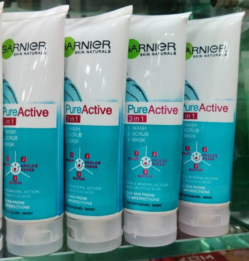 Four Garnier Pure Active 3in1 skincare tubes on a green shelf.