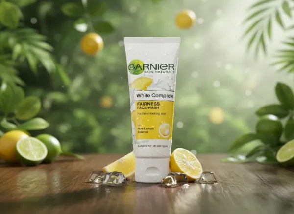 Garnier White Complete fairness face wash tube with lemons and limes on a wooden surface