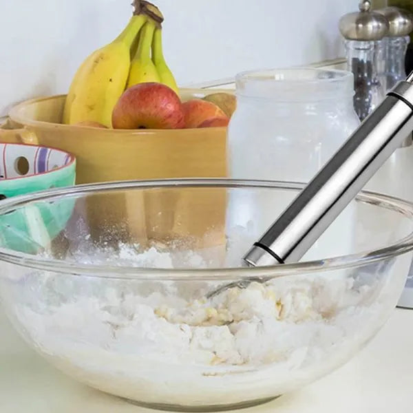Glass bowl with ice cream, bananas, and apples on a kitchen counter