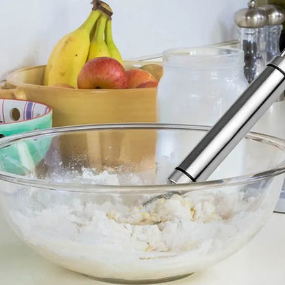 Glass bowl with ice cream, bananas, and apples on a kitchen counter