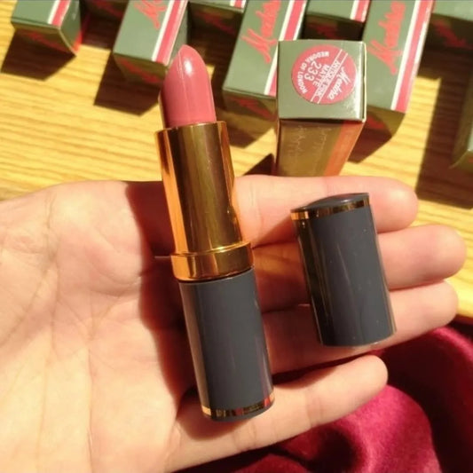 Lipstick held in a hand with red boxes in the background