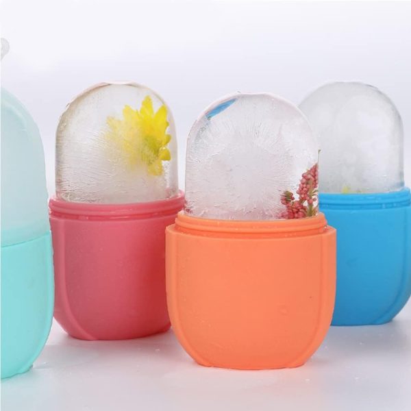 Colorful containers with transparent lids filled with small plants on a white background