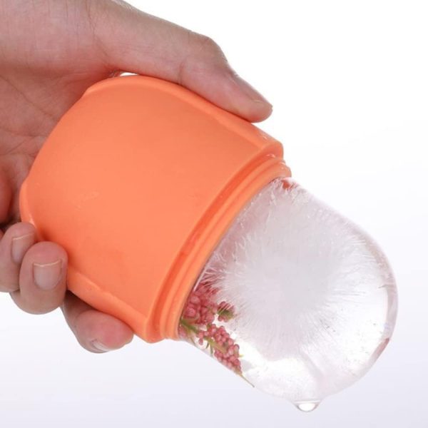 Hand holding an orange silicone ice cream container with a clear lid on a white background