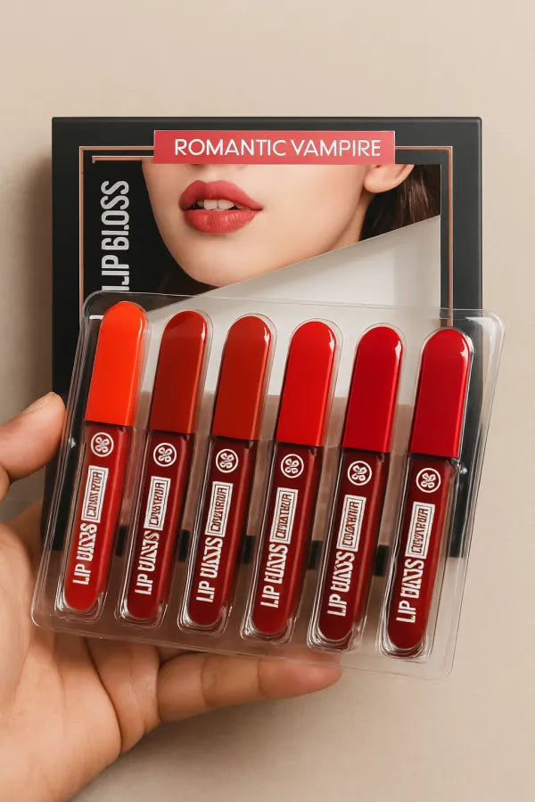 Set of red lip glosses in a clear packaging with 'Lip Vans' branding, held by a hand against a neutral background.