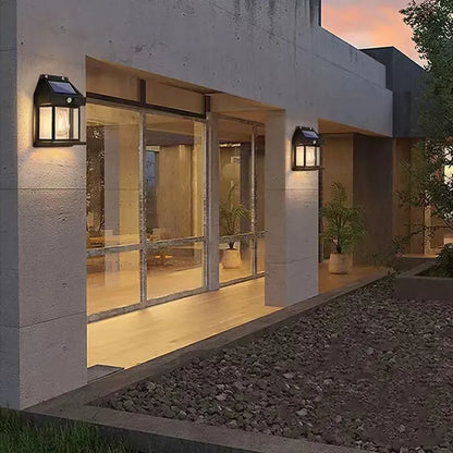 Modern building exterior with solar lights on a concrete wall.